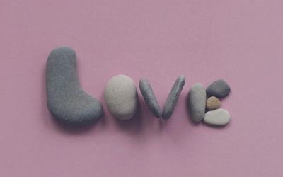 Smooth stones stacked peacefully on a neutral background.